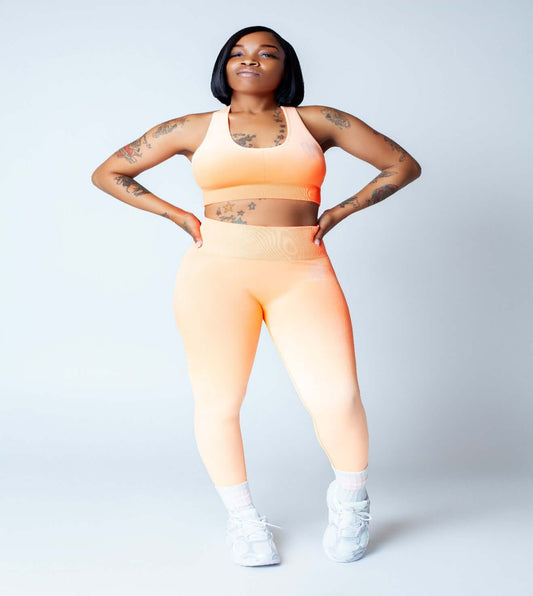 Cotton Candy Luxe Set showcased by a woman posing in a orange ombre, highlighting premium comfort loungewear.